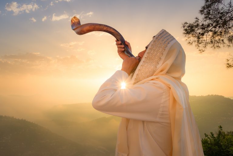 A,Jewish,Man,Blowing,The,Shofar,(ram's,Horn),,Which,Is